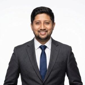 Create professional headshot on a white background from this attached photo 11 (1)