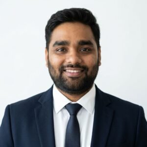 Create professional headshot on a white background from this attached photo 11 (7)